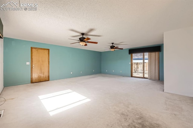 spare room featuring carpet floors and a textured ceiling