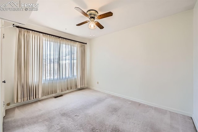 empty room with a ceiling fan, baseboards, visible vents, and carpet flooring