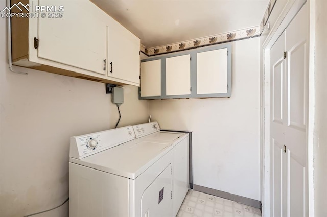 washroom with cabinet space, baseboards, washer and clothes dryer, and light floors