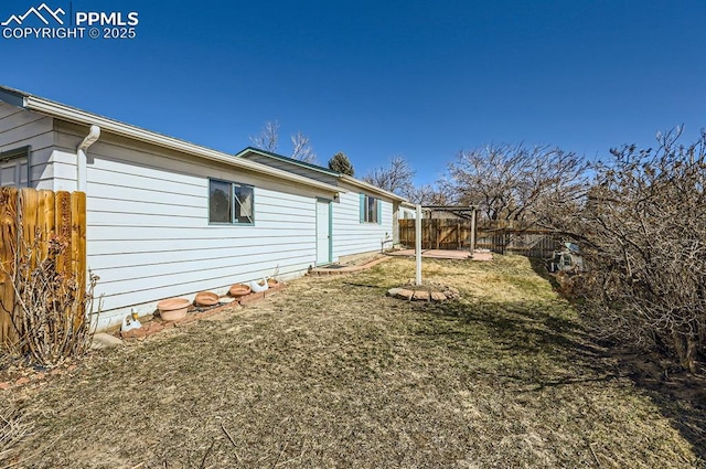 view of home's exterior with a fenced backyard and a yard