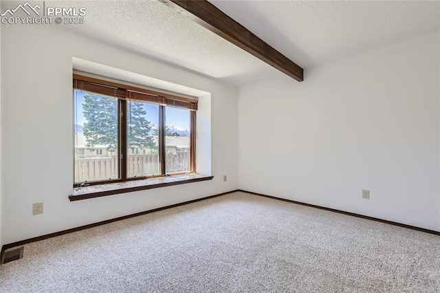 carpeted empty room featuring baseboards, a textured ceiling, visible vents, and beam ceiling