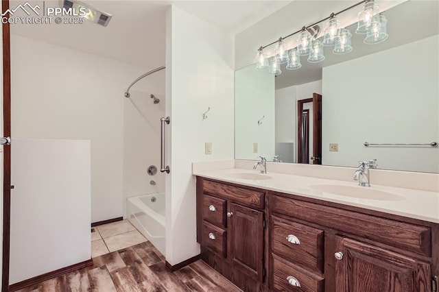 full bath with wood finished floors, a sink, shower / tub combination, and double vanity