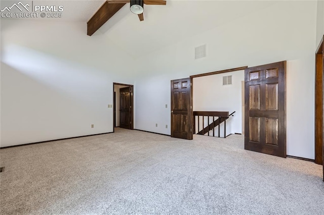 carpeted spare room featuring high vaulted ceiling, baseboards, visible vents, and beamed ceiling