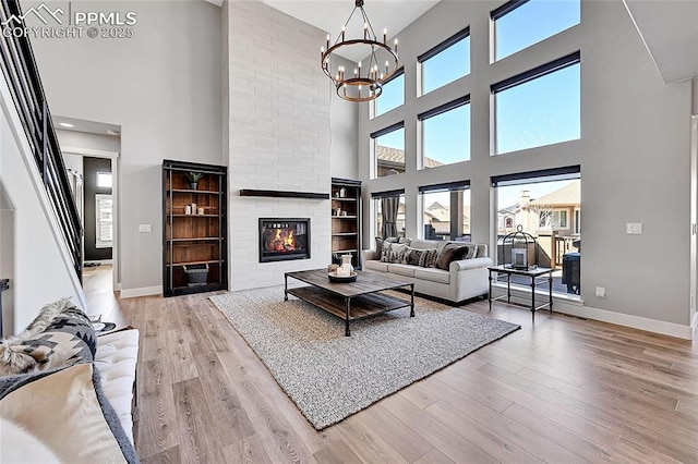 living room with plenty of natural light, baseboards, and wood finished floors