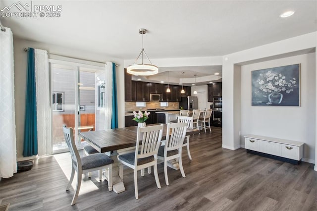 dining room featuring baseboards, dark wood finished floors, and recessed lighting