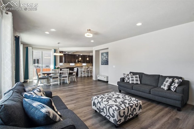 living room with dark wood-style floors, baseboards, and recessed lighting