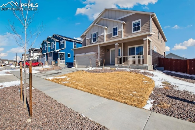 view of front of property featuring a garage, driveway, covered porch, fence, and board and batten siding