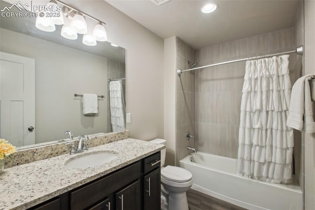 full bath featuring shower / tub combo with curtain, vanity, toilet, and wood finished floors