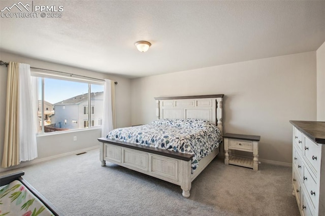 carpeted bedroom with visible vents and baseboards