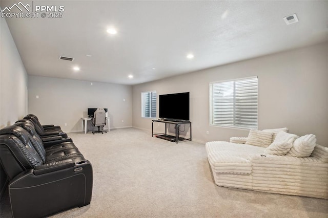 living room featuring carpet floors, visible vents, a wealth of natural light, and recessed lighting