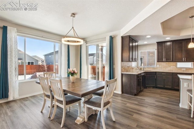 dining space featuring recessed lighting, dark wood finished floors, and baseboards