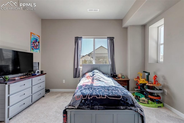 bedroom with light carpet, visible vents, and baseboards