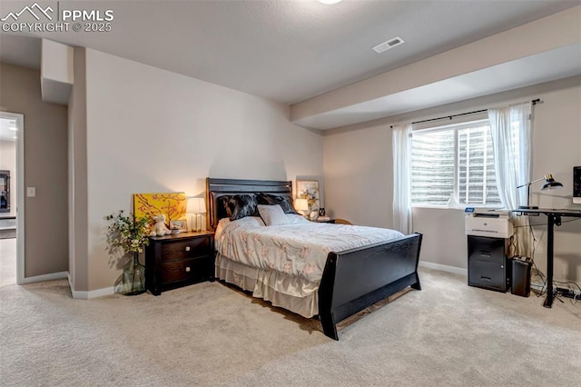 bedroom with carpet floors, visible vents, and baseboards