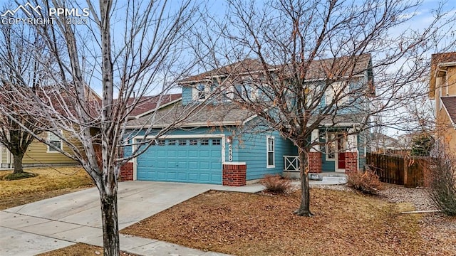 view of front of property featuring driveway, brick siding, an attached garage, and fence