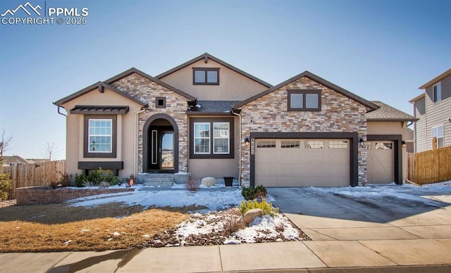 view of front of home featuring an attached garage, fence, concrete driveway, and stucco siding