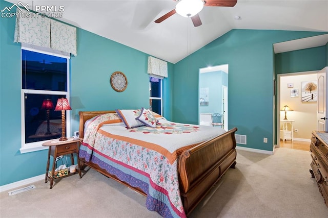 bedroom with light carpet, ensuite bath, visible vents, and lofted ceiling