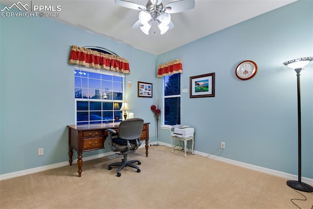 office featuring baseboards, ceiling fan, and light colored carpet