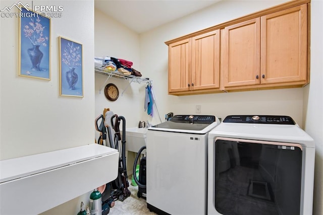 clothes washing area featuring cabinet space and independent washer and dryer