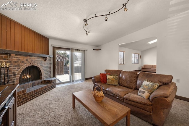 living area with a brick fireplace, carpet flooring, and a healthy amount of sunlight