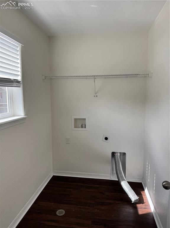 laundry area with laundry area, hookup for an electric dryer, baseboards, and wood finished floors