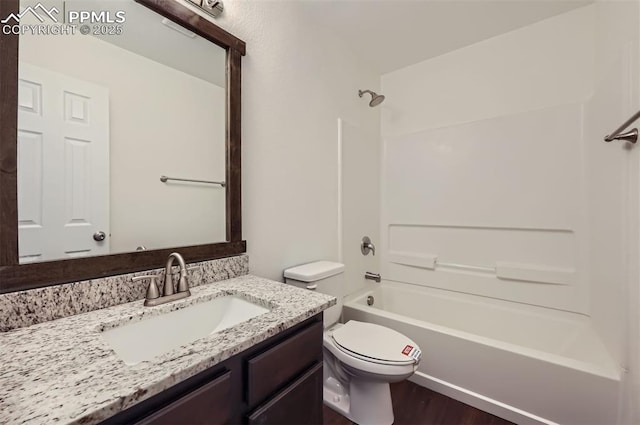 full bathroom featuring  shower combination, vanity, and toilet