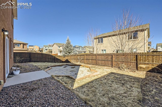 view of yard with a residential view, a patio area, and a fenced backyard