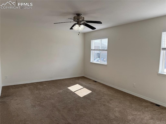 empty room with a ceiling fan, carpet, visible vents, and baseboards