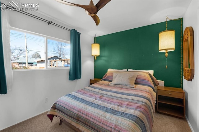 carpeted bedroom with ceiling fan and baseboards