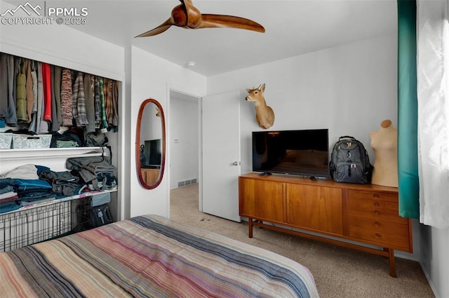 carpeted bedroom featuring visible vents and a ceiling fan