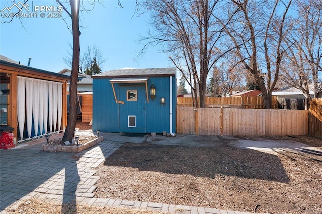 view of outdoor structure featuring fence private yard and an outdoor structure