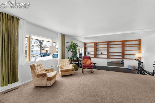 living area with carpet floors and visible vents