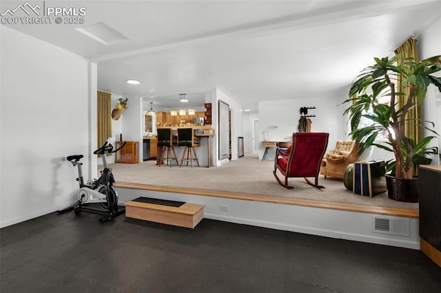 exercise area with a dry bar, recessed lighting, visible vents, attic access, and baseboards