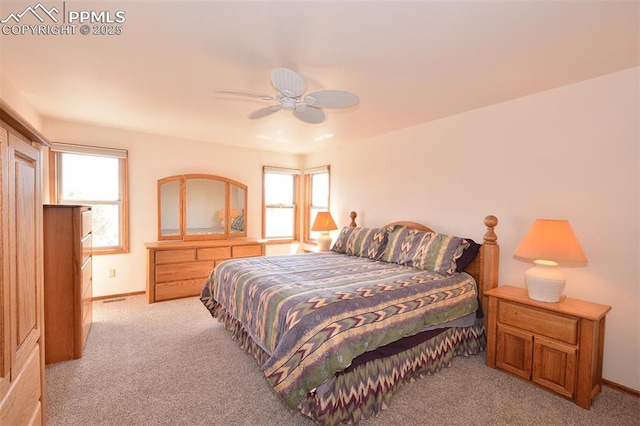 bedroom featuring light carpet, ceiling fan, and baseboards