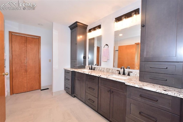 full bathroom with double vanity, visible vents, and a sink