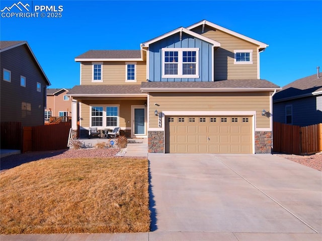 craftsman house with concrete driveway, covered porch, an attached garage, board and batten siding, and fence