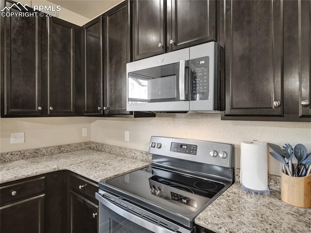 kitchen with dark brown cabinetry and stainless steel appliances