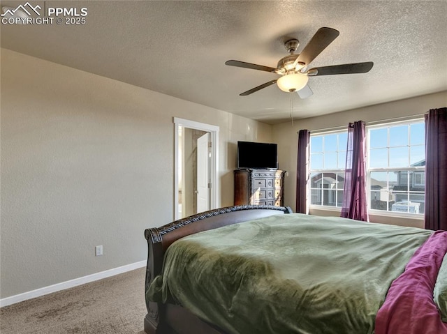 carpeted bedroom with a textured ceiling, a ceiling fan, and baseboards