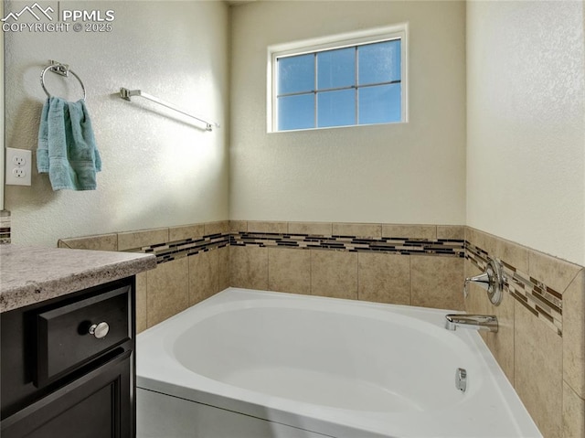 full bath with vanity and a bath