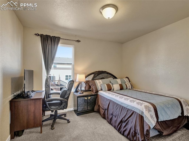 bedroom with light carpet and a textured ceiling