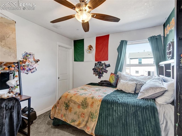 carpeted bedroom with ceiling fan and baseboards