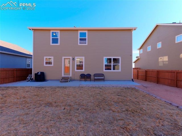 back of house with entry steps, a patio area, and a fenced backyard