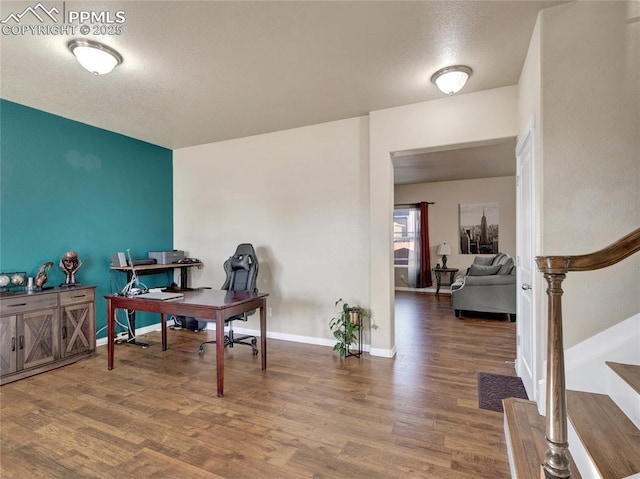 office space with baseboards and wood finished floors