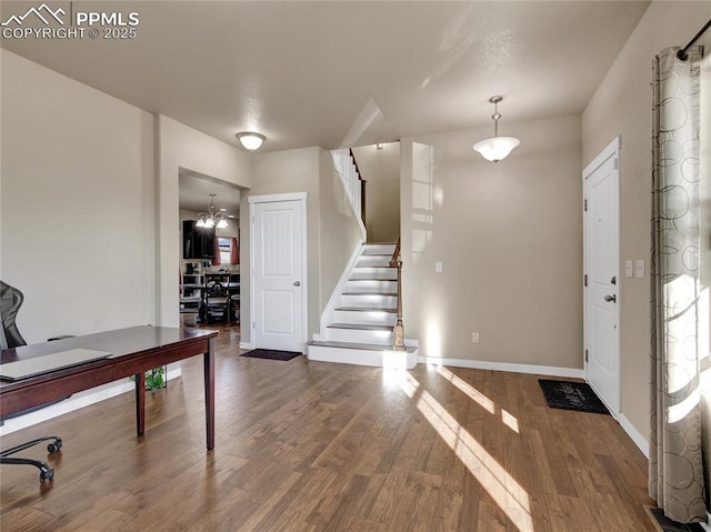 entrance foyer featuring stairs, wood finished floors, and baseboards