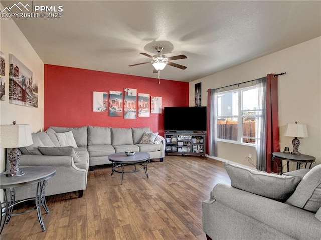 living area featuring a ceiling fan and wood finished floors