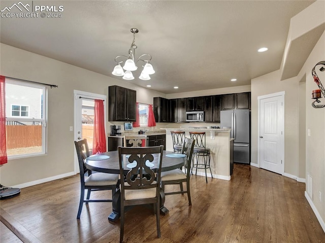 dining room with a notable chandelier, baseboards, dark wood-type flooring, and recessed lighting