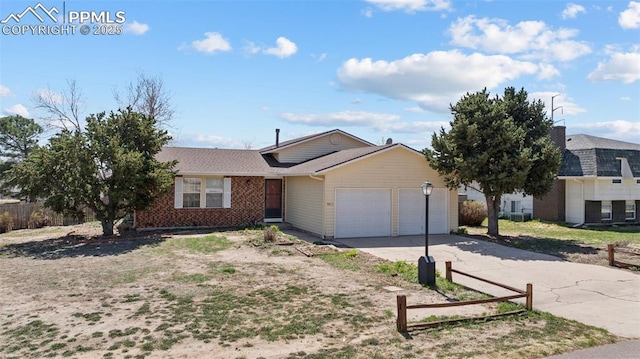 ranch-style house with concrete driveway, brick siding, roof with shingles, and a garage