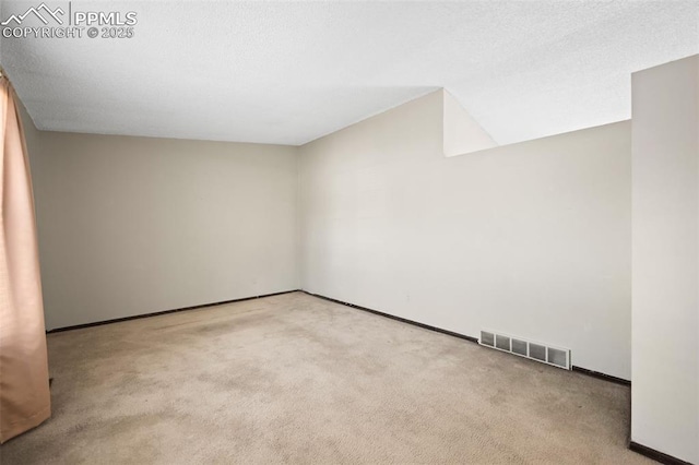 empty room featuring baseboards, carpet, and visible vents