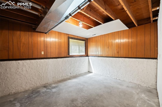 unfinished below grade area featuring wood walls