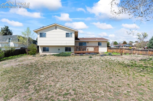 back of property featuring a lawn, a fenced backyard, and a deck