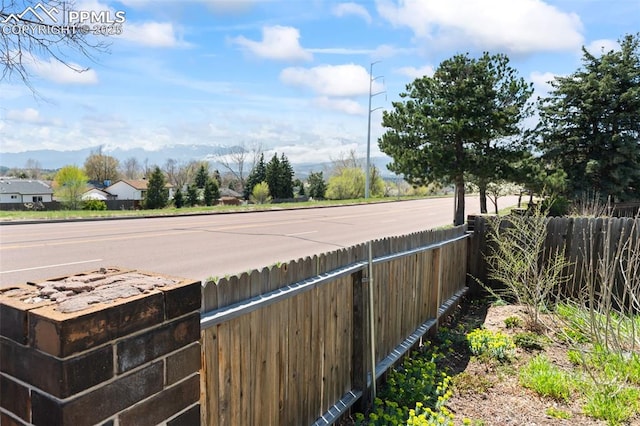 exterior space featuring fence and a mountain view